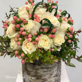 Bouquet of white roses with pink berries in a silver vase .Ultimate Floral Designs, Great Falls, VA