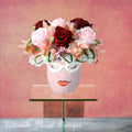 Floral arrangement in a vase shaped like a face with glasses, pink and red preserved roses last one year. ultimate floral designs, Great Falls, VA