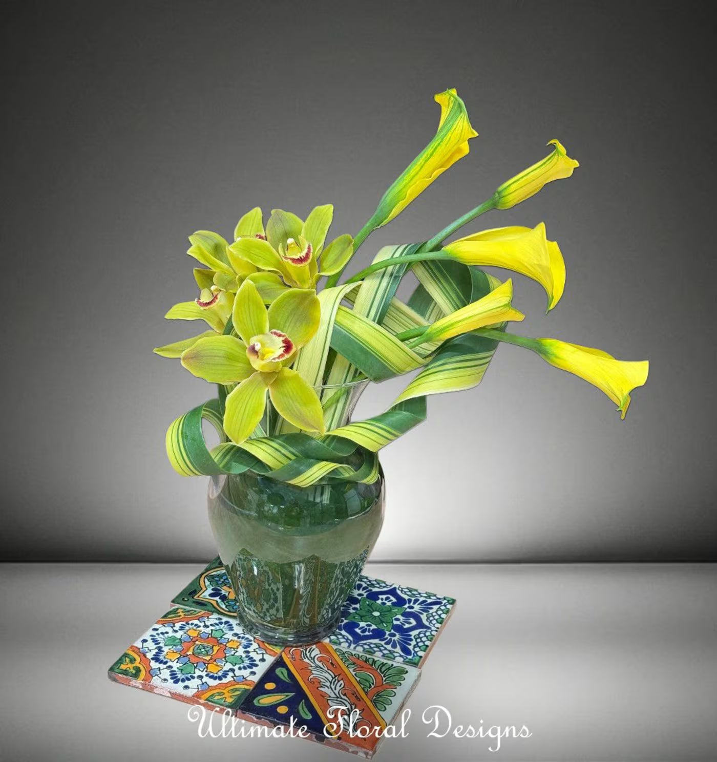 Yellow calla lilies and green cymbidium orchids in a sleek modern arrangement — Ultimate Floral Designs, Great Falls, VA
