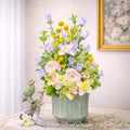 Ranunculus, yellow tulips, lavender campanula, and narcissus in a garden-style arrangement — Ultimate Floral Designs, Great Falls, VA
