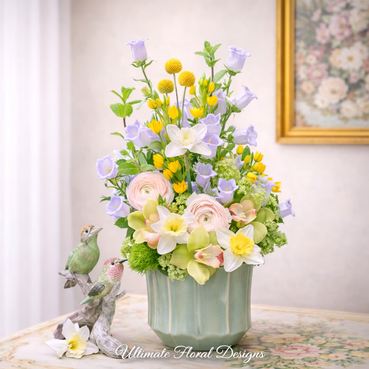 Ranunculus, yellow tulips, lavender campanula, and narcissus in a garden-style arrangement — Ultimate Floral Designs, Great Falls, VA
