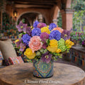 Roses, hyacinths, and hellebores in a vibrant European garden-style arrangement — Ultimate Floral Designs, Great Falls, VA
